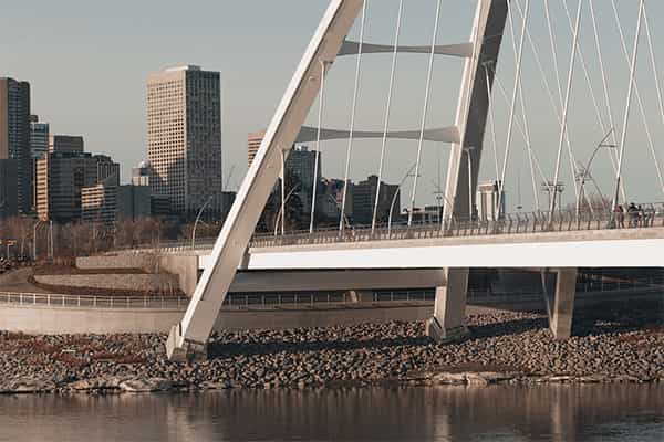 a modern bridge with a city in the background